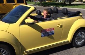 kid in yellow car